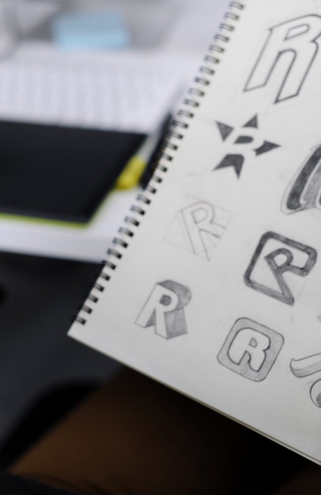 Hand Holding Notebook With Drew Brand Logo Creative Design Ideas